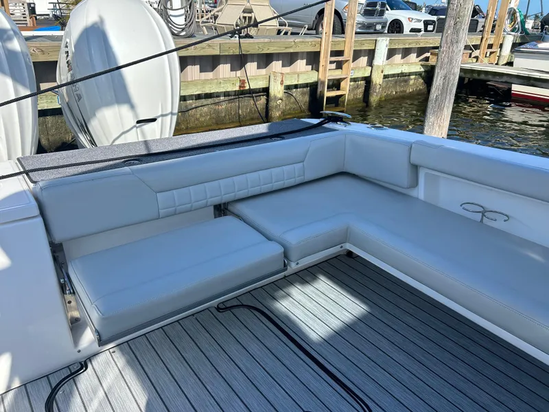Slide: The Image of 2019 Everglades 340DC boat with spacious seating area at the dock. - 20