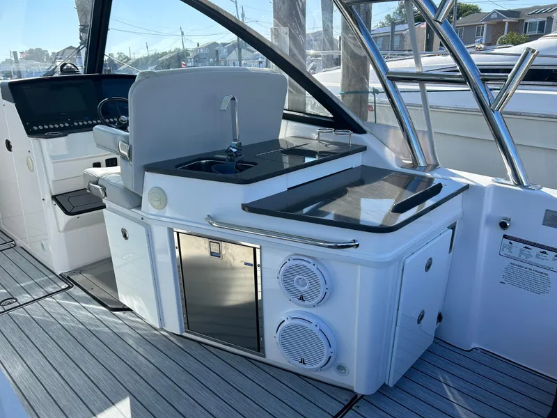 Slide: The Image of 2019 Everglades 340DC boat interior with kitchenette and modern amenities. - 24
