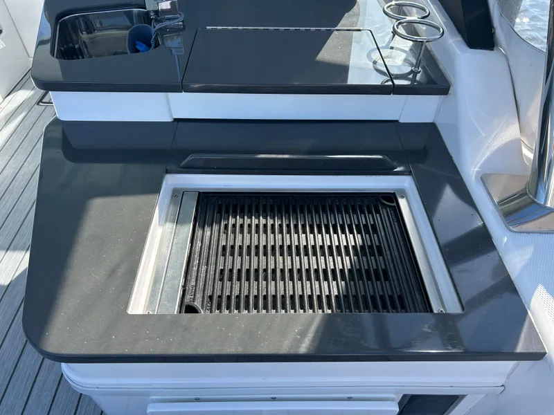 Slide: The Image of Outdoor kitchen on 2019 Everglades 340DC boat with grill and sink. - 26
