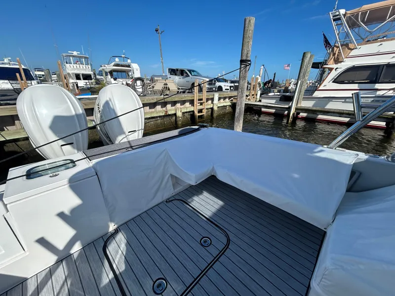 Slide: The Image of 2019 Everglades 340DC boat docked at marina with twin outboard engines. - 28