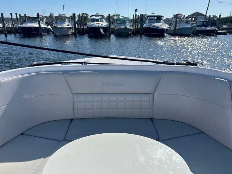 Slide: The Image of 2019 Everglades 340DC boat interior with marina view in the background. - 5