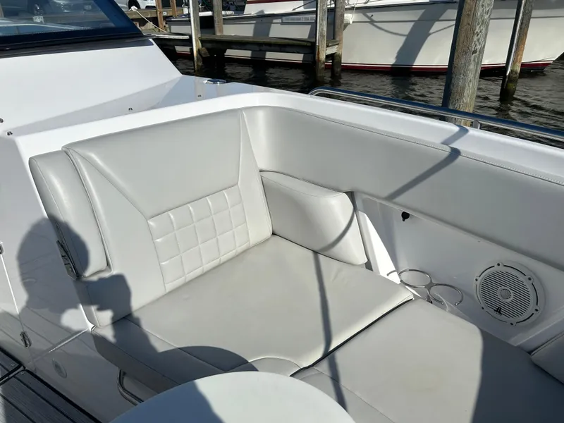 Slide: The Image of 2019 Everglades 340DC boat interior seating area with cup holders and speaker. - 6