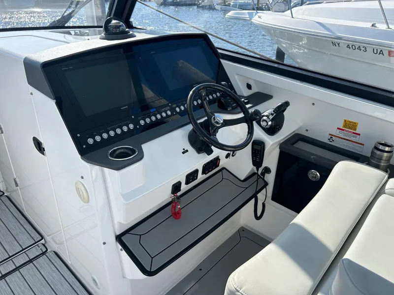 Slide: The Image of 2019 Everglades 340DC boat helm with modern controls and navigation screens. - 8