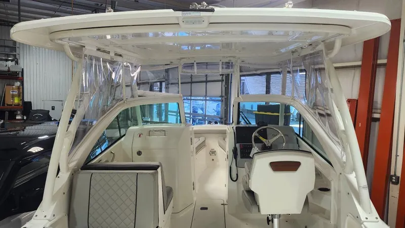 Slide: The Image of 2024 Pursuit DC 246 Dual Console boat interior with helm and seating. - 1