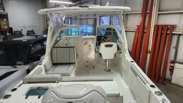 Slide: The Image of 2024 Pursuit DC 246 Dual Console boat interior in a garage setting. - 15