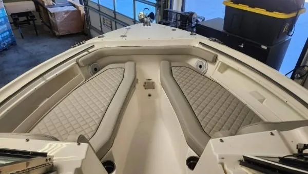 Slide: The Image of 2024 Pursuit DC 246 Dual Console boat interior with cushioned seating. - 16