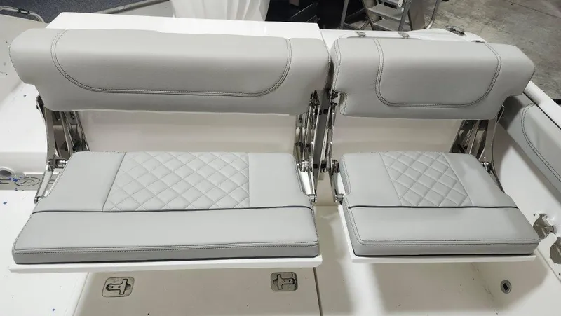 Slide: The Image of 2024 Pursuit DC 246 Dual Console boat seats with elegant gray upholstery. - 2