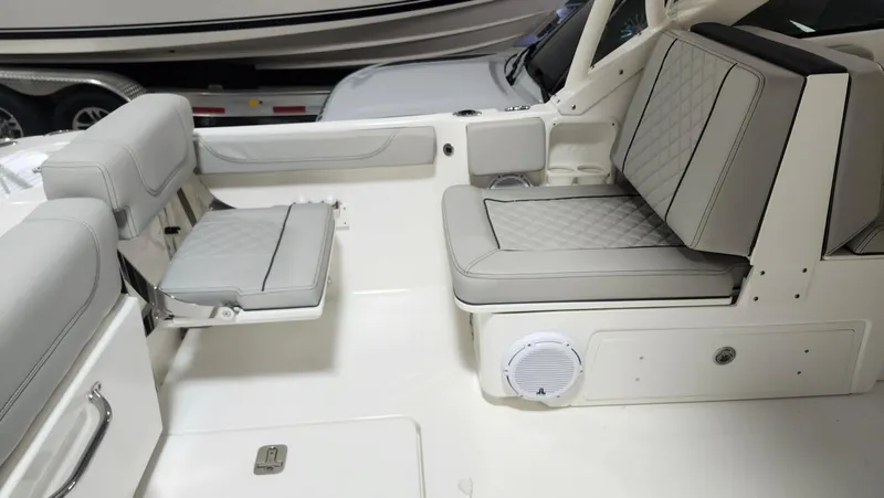 Slide: The Image of 2024 Pursuit DC 246 Dual Console boat interior with cushioned seating and sleek design. - 3