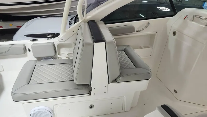 Slide: The Image of 2024 Pursuit DC 246 Dual Console boat interior with cushioned seating. - 8
