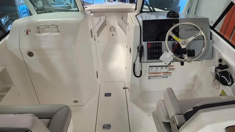 Slide: The Image of 2024 Pursuit DC 246 Dual Console boat interior with steering wheel and seating. - 9