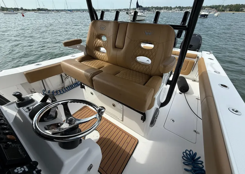 Slide: The Image of 2020 Southport 33 FE boat interior with tan leather seating and steering wheel. - 10