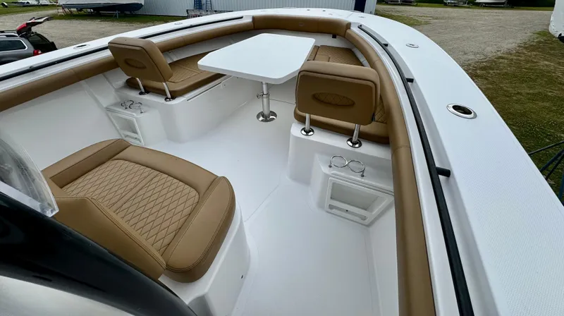 Slide: The Image of 2020 Southport 33 FE boat interior with tan seating and white table. - 12