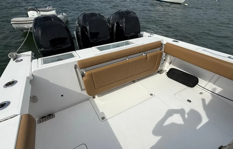 Slide: The Image of 2020 Southport 33 FE boat with triple outboard engines and tan seating on the deck. - 15