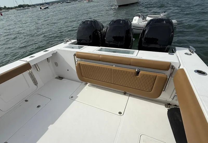Slide: The Image of 2020 Southport 33 FE boat with triple engines and tan seating on open water. - 16