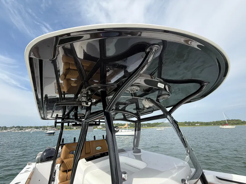 Slide: The Image of 2020 Southport 33 FE boat with sleek black T-top on calm water. - 19