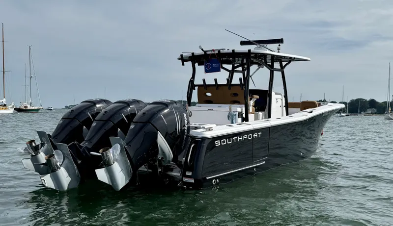 Slide: The Image of 2020 Southport 33 FE boat with triple outboard engines on water. - 2