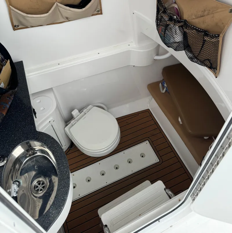 Slide: The Image of 2020 Southport 33 FE boat interior with sink, toilet, and storage compartments. - 20