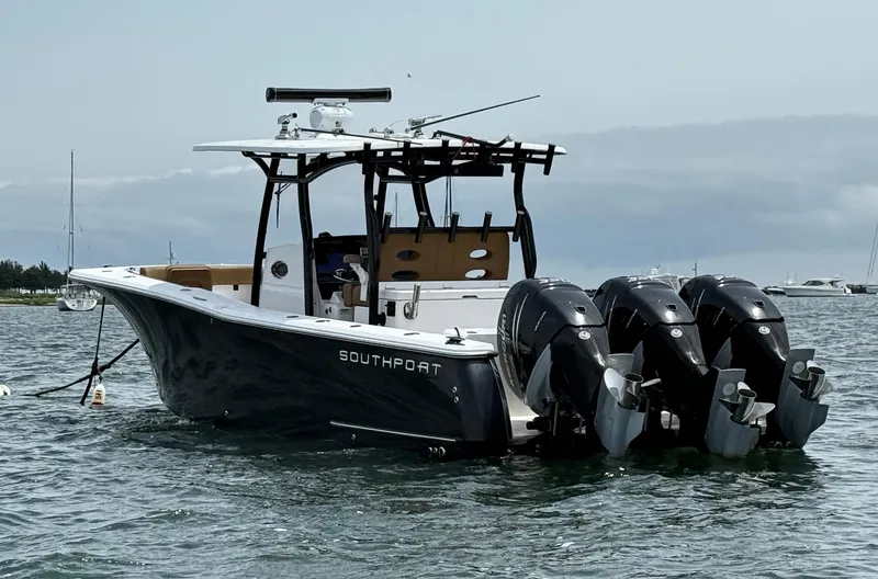 Slide: The Image of 2020 Southport 33 FE boat with triple outboard engines on water. - 3