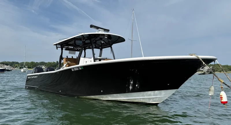 Slide: The Image of 2020 Southport 33 FE boat on water, black hull, clear sky background. - 4