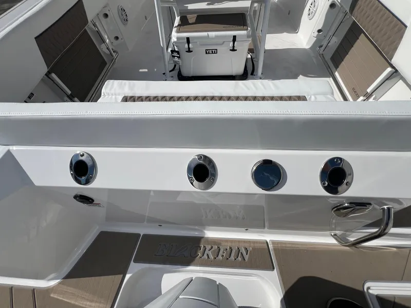 Slide: The Image of 2025 Blackfin 222 CC center console boat interior with rod holders and Yeti cooler. - 11