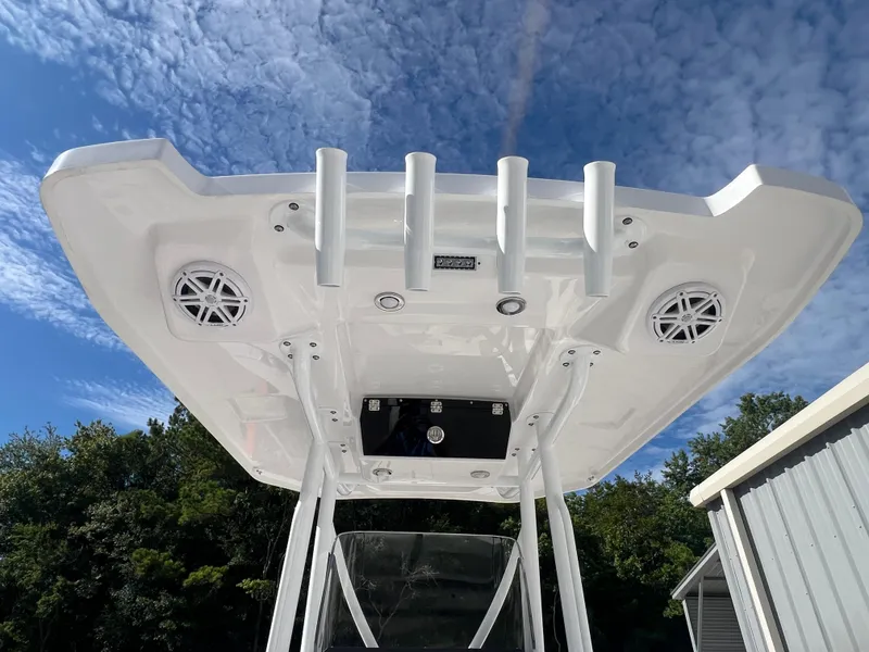 Slide: The Image of 2025 Blackfin 222 CC boat T-top with rod holders and speakers. - 13