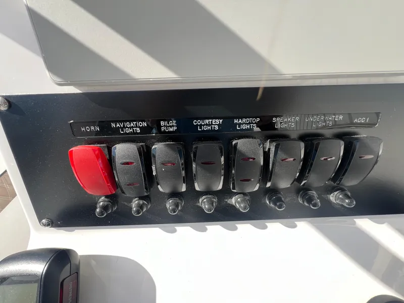 Slide: The Image of Control panel of a 2025 Blackfin 222 CC boat with labeled switches. - 21