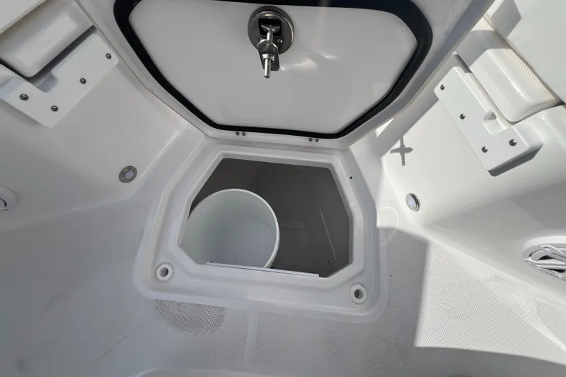 Slide: The Image of 2025 Blackfin 222 CC boat storage compartment with white bucket. - 33