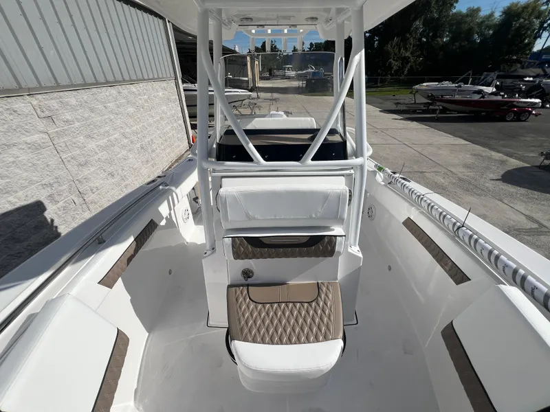 Slide: The Image of 2025 Blackfin 222 CC center console boat, white interior, docked at marina. - 6