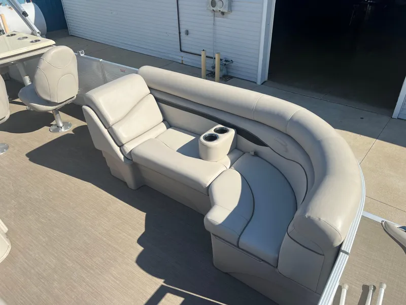Slide: The Image of 2017 Bennington 24SPDX pontoon boat with beige seating and cup holders. - 10