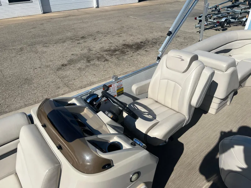Slide: The Image of 2017 Bennington 24SPDX boat interior with captain's chair and steering console. - 14