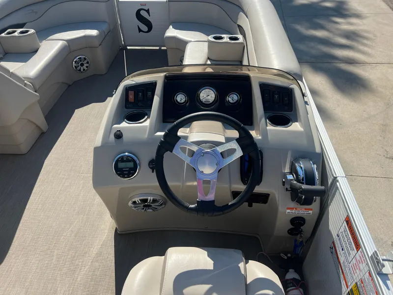 Slide: The Image of 2017 Bennington 24SPDX boat dashboard with steering wheel and control panel. - 15
