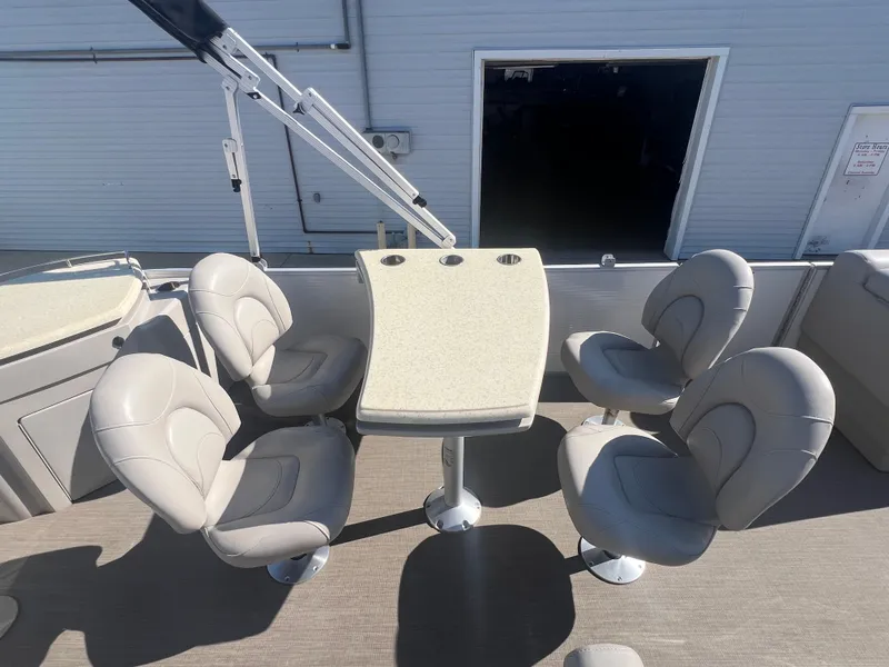 Slide: The Image of 2017 Bennington 24SPDX boat with seating and table setup. - 16