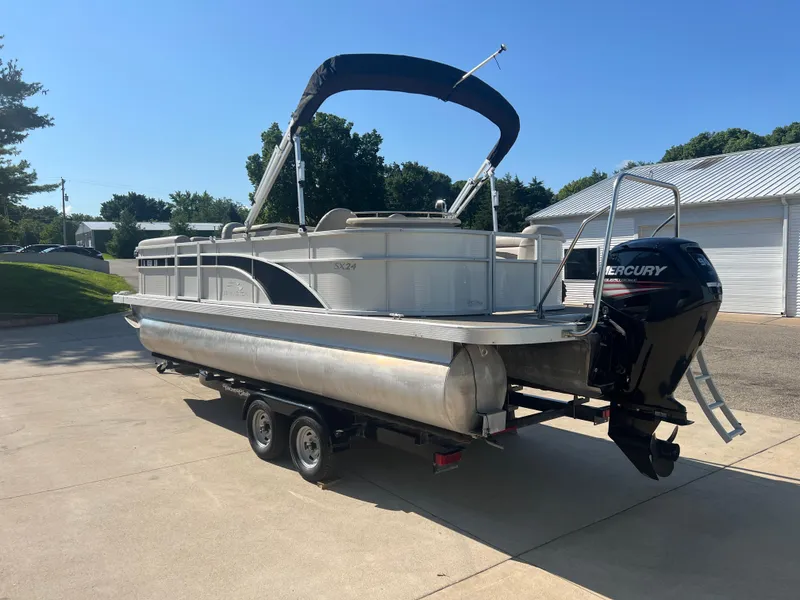 Slide: The Image of 2017 Bennington 24SPDX pontoon boat on trailer with Mercury outboard motor. - 6