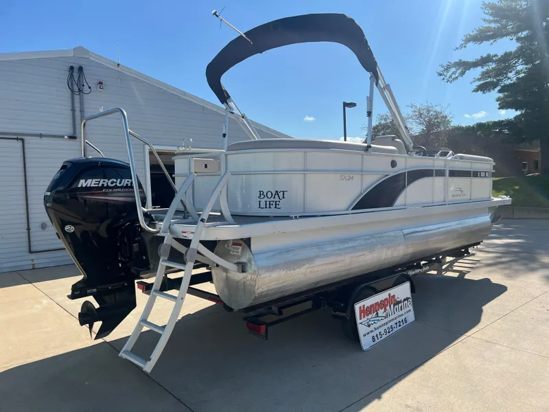 Slide: The Image of 2017 Bennington 24SPDX pontoon boat with Mercury outboard motor on trailer. - 8