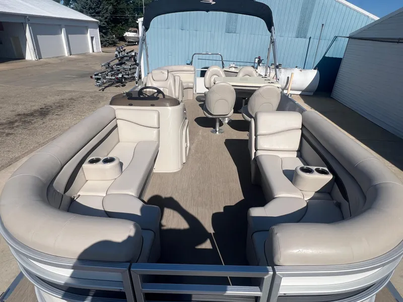 Slide: The Image of 2017 Bennington 24SPDX pontoon boat with beige seating and black canopy. - 9