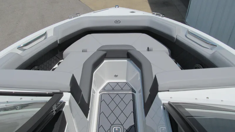 Slide: The Image of 2025 Cobalt R4 boat bow seating area with gray upholstery. - 11