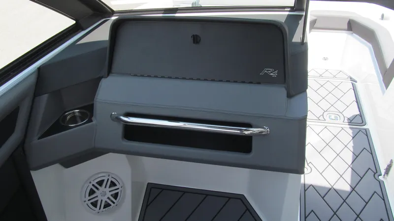 Slide: The Image of 2025 Cobalt R4 boat interior with storage compartment and cup holder. - 8