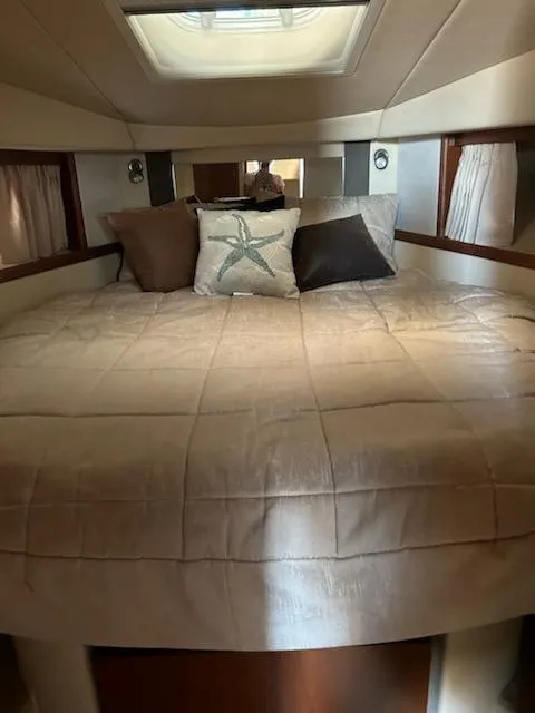Slide: The Image of 2007 Sea Ray 380 Sundancer cabin with cozy bed and decorative pillows. - 12