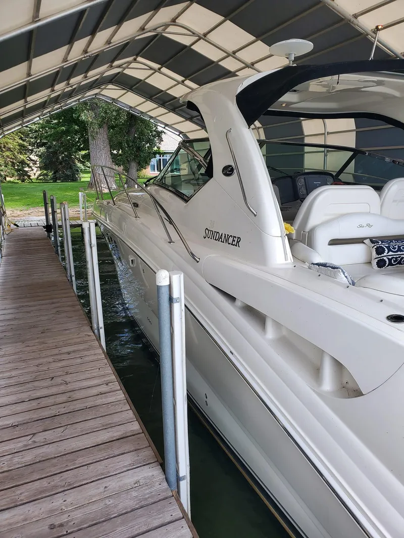 Slide: The Image of 2007 Sea Ray 380 Sundancer docked under a covered marina. - 2