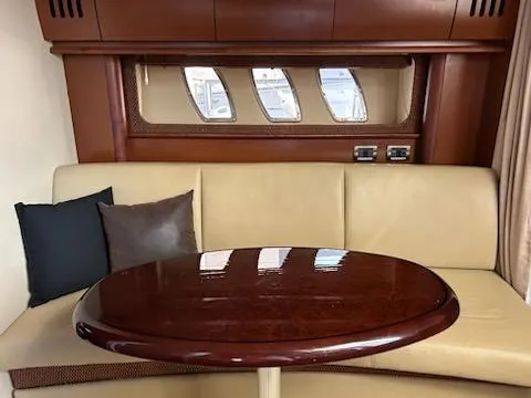 Slide: The Image of Interior of 2007 Sea Ray 380 Sundancer with beige seating and wooden table. - 7