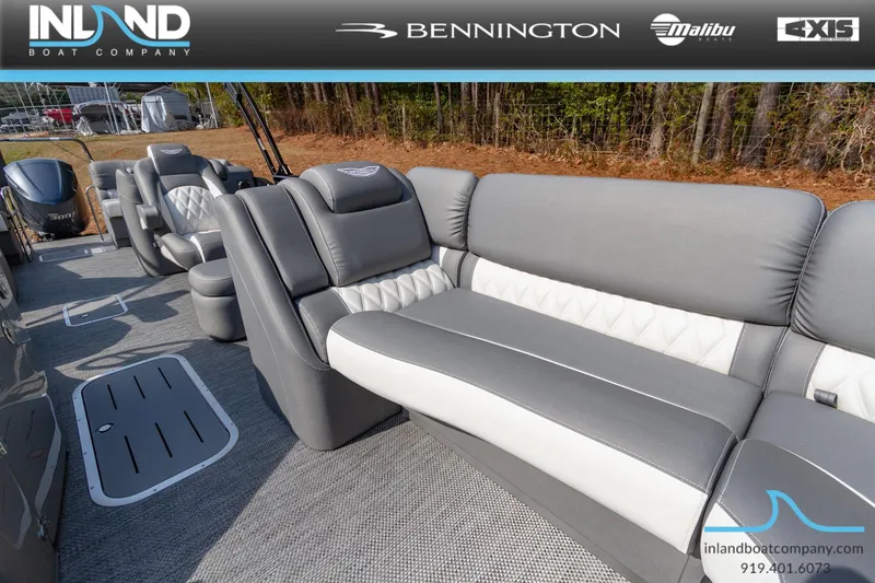 Slide: The Image of 2024 Bennington 23 RFB boat interior with gray and white seating, showcased by Inland Boat Company. - 23