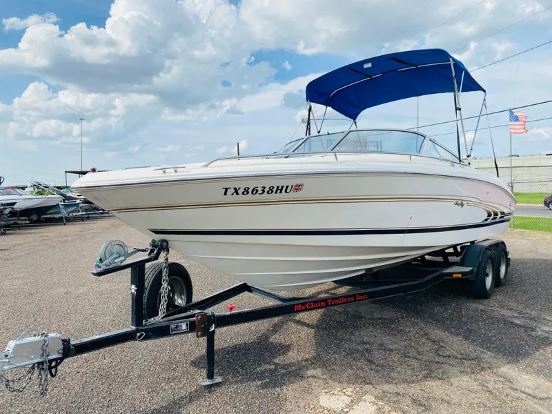 The Image of 1997 Sea Ray 230 boat on trailer with blue canopy, registration TX8638HU. - 1