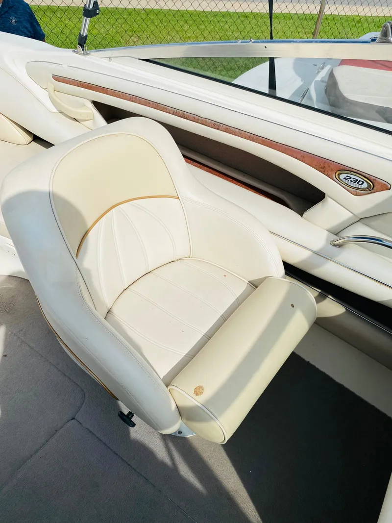 Slide: The Image of 1997 Sea Ray 230 boat interior with white leather seat. - 7