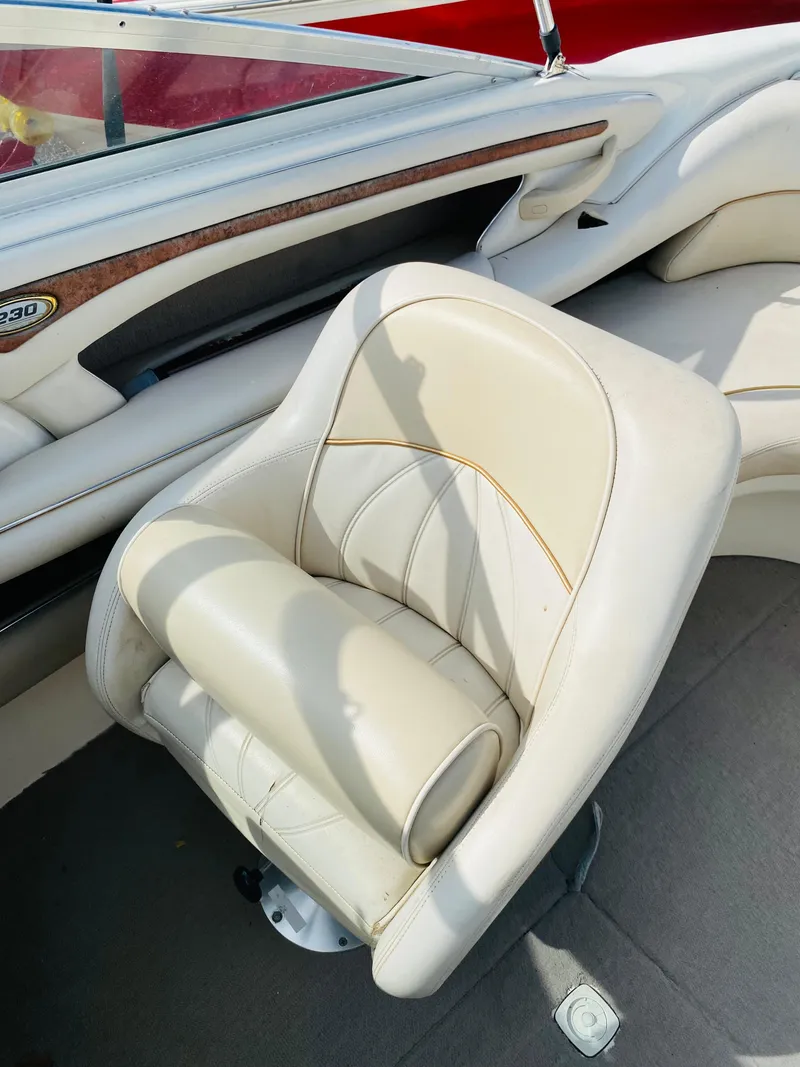 Slide: The Image of 1997 Sea Ray 230 boat interior with white leather seating. - 8