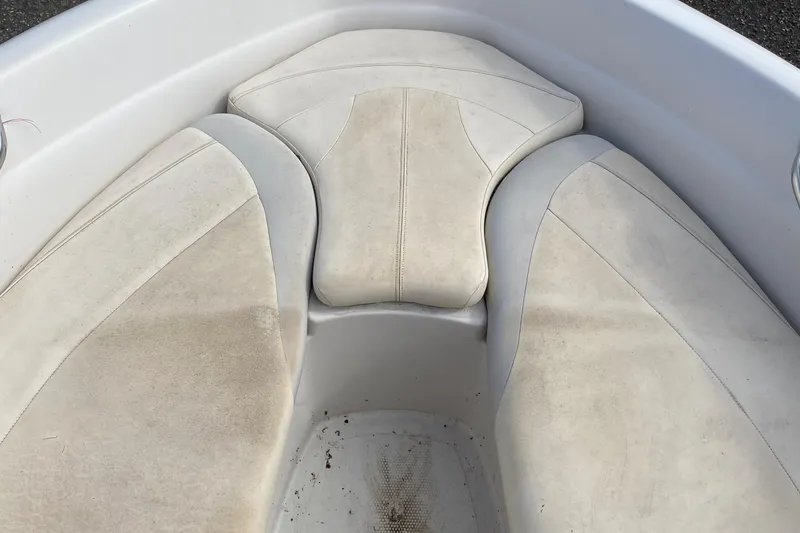 Slide: The Image of 2010 Tahoe Q5i boat interior with white cushioned seating. - 11