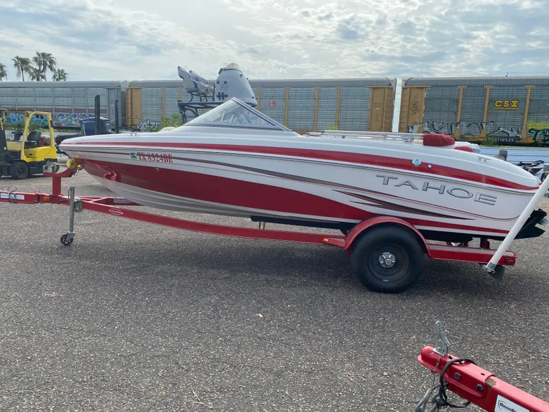 Slide: The Image of 2010 Tahoe Q5i red and white speedboat on trailer. - 3