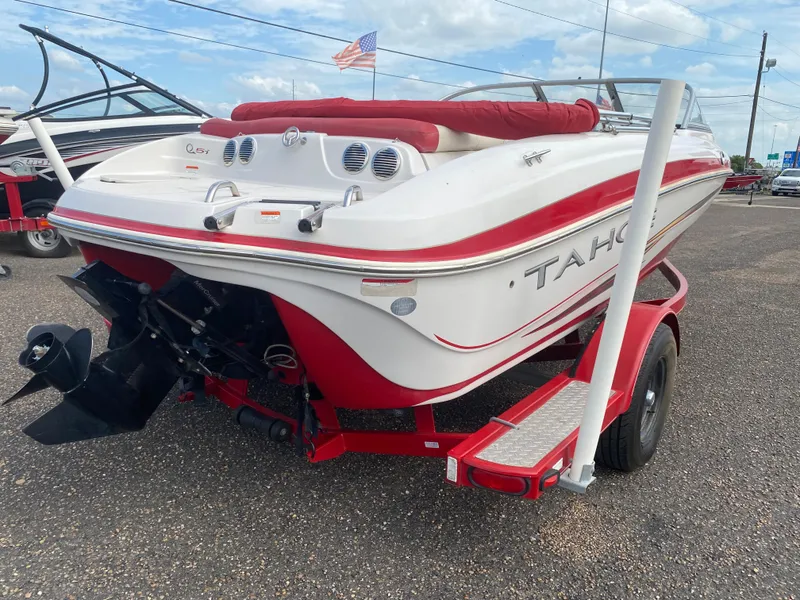 Slide: The Image of 2010 Tahoe Q5i boat with red and white design on trailer. - 6