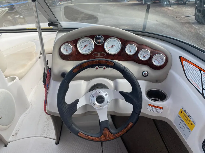 Slide: The Image of 2010 Tahoe Q5i boat dashboard with steering wheel and gauges. - 7