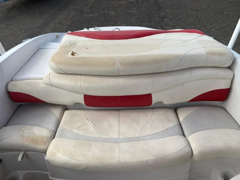 Slide: The Image of 2010 Tahoe Q5i boat with worn red and white leather seats. - 8