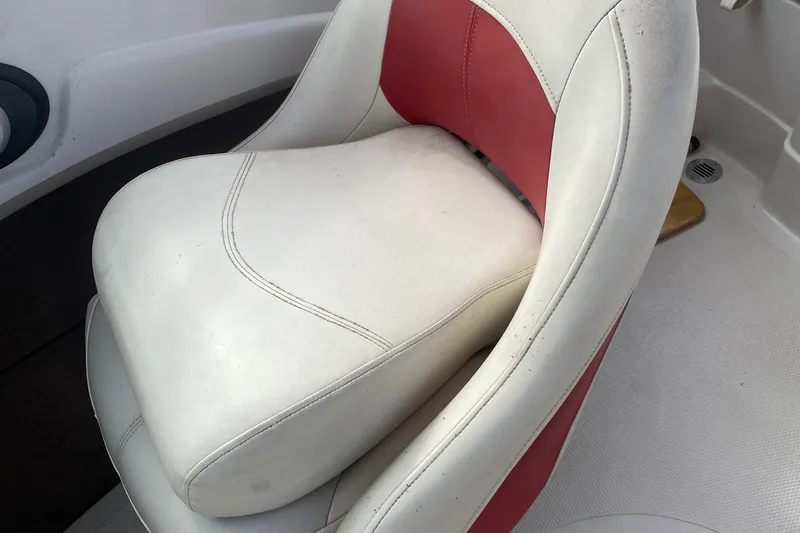 Slide: The Image of 2010 Tahoe Q5i boat seat with white and red upholstery. - 9